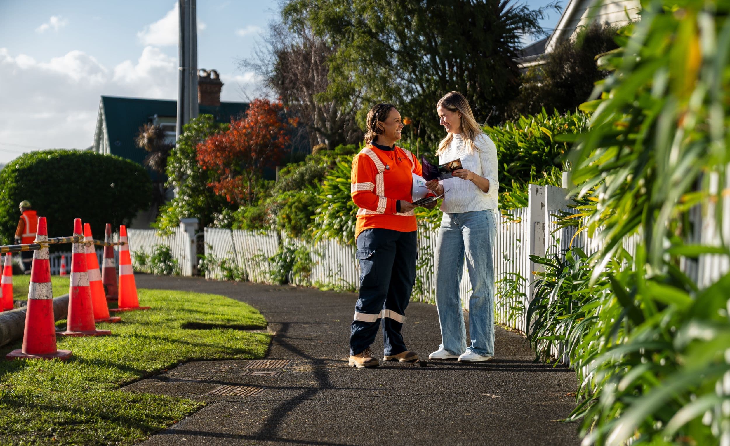 work contractor talking to customer on residential street